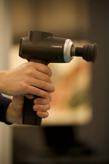 person holding black and gray cordless hand drill